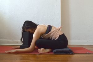 yoga poses for anxiety - sukasana - cross legged forward fold with blocks